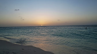 Serene Ocean Sunset Over Sandy Beach Horizon