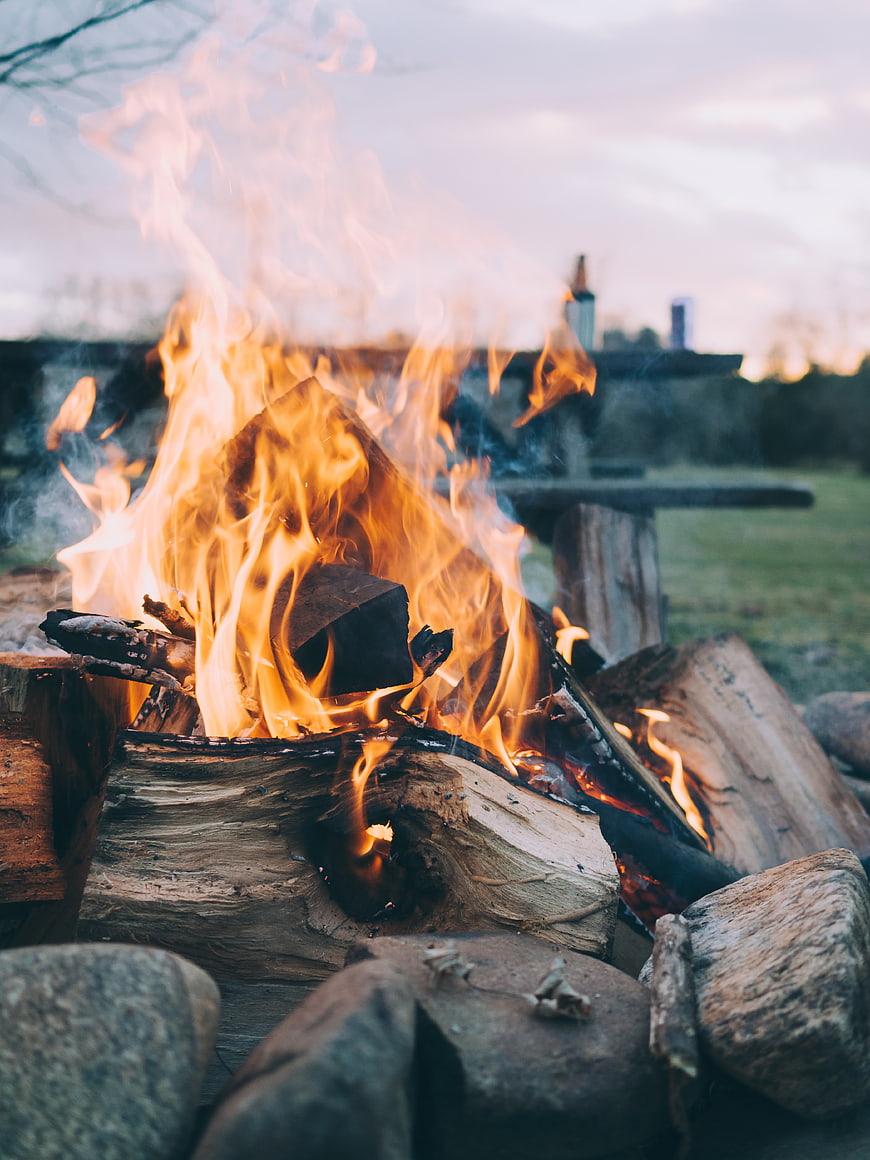 Campfire Burning in Outdoor Stone Fire Pit at Dusk