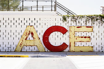 Vintage ACE Letters on White Brick Wall