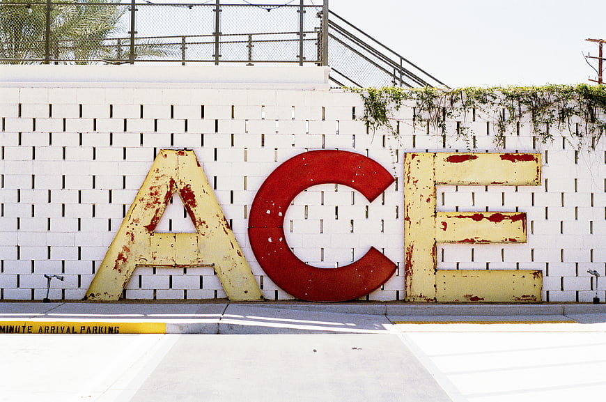 Vintage ACE Letters on White Brick Wall