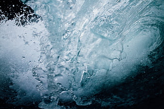 Abstract underwater view of turbulent ocean waves and bubbles