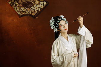Woman in Traditional Chinese Hanfu Holding Calligraphy Brush