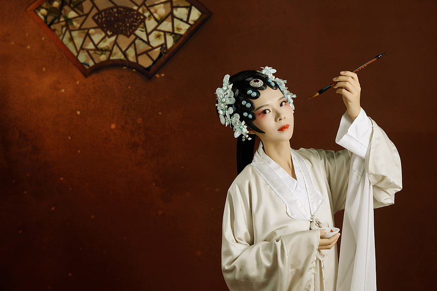 Woman in Traditional Chinese Hanfu Holding Calligraphy Brush