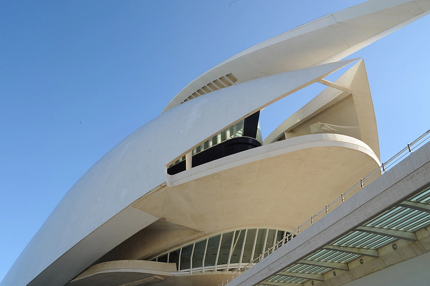 Low angle view of modern white curved architecture against blue sky