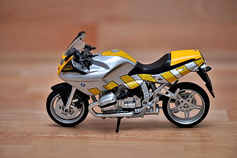 Yellow and Silver BMW Motorcycle Model on Wooden Floor