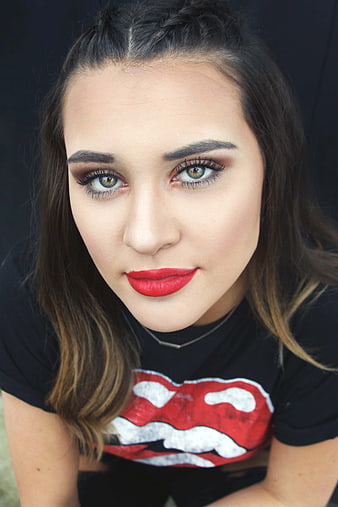 Close-up portrait of young woman with red lipstick and graphic tee