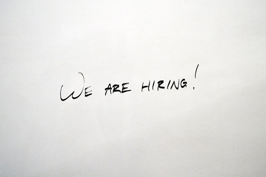 Handwritten We Are Hiring Text on White Paper