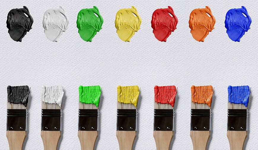 Colorful Paint Brushes and Dabs on White Canvas Background