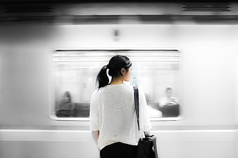 Woman waiting for subway train on platform