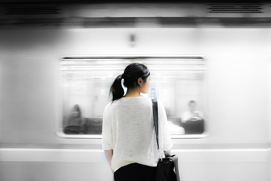 Woman waiting for subway train on platform