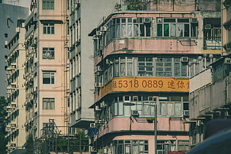 Weathered Pink Apartment Building In Hong Kong Urban Street Scene