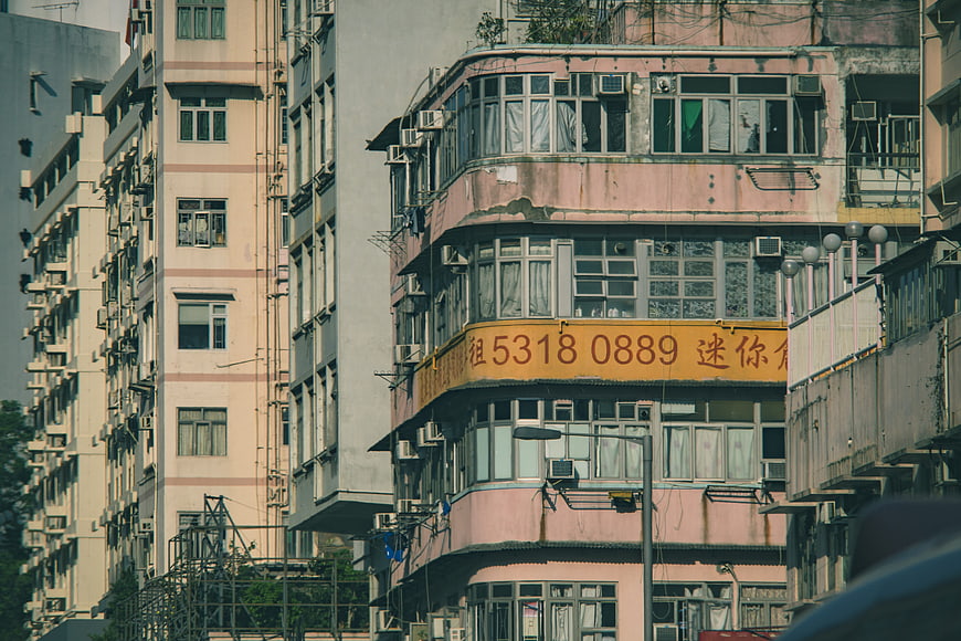 Weathered Pink Apartment Building In Hong Kong Urban Street Scene