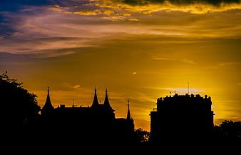 Silhouette of Gothic Architecture Against Golden Sunset Sky