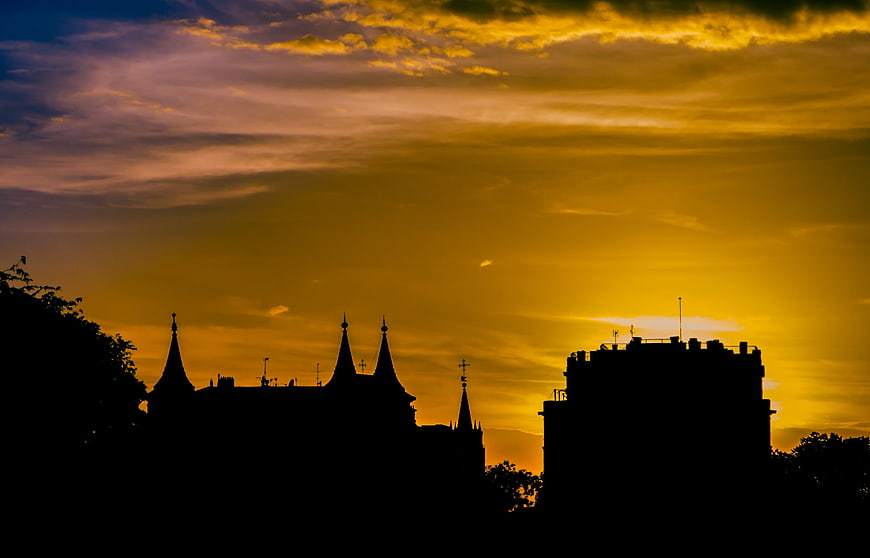 Silhouette of Gothic Architecture Against Golden Sunset Sky
