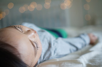 Close-up of sleeping baby with bokeh lights