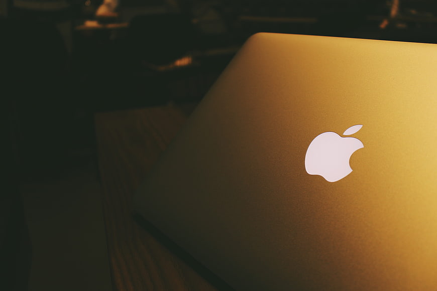Close-up of a gold Apple MacBook laptop lid with logo