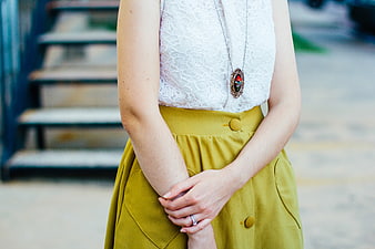 Woman in White Lace Top and Mustard Skirt