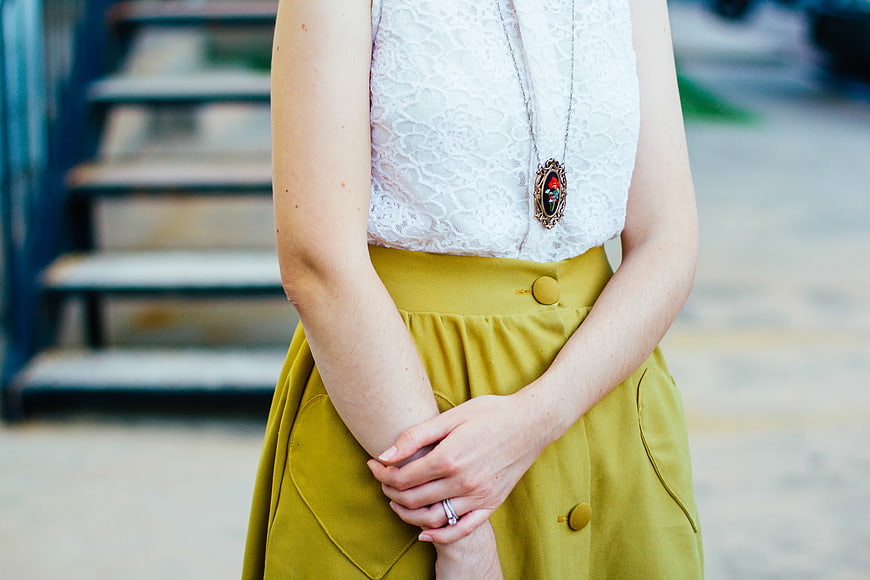 Woman in White Lace Top and Mustard Skirt
