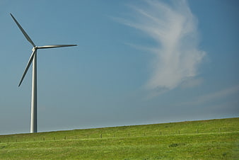 Wind Turbine on Green Hill with Blue Sky