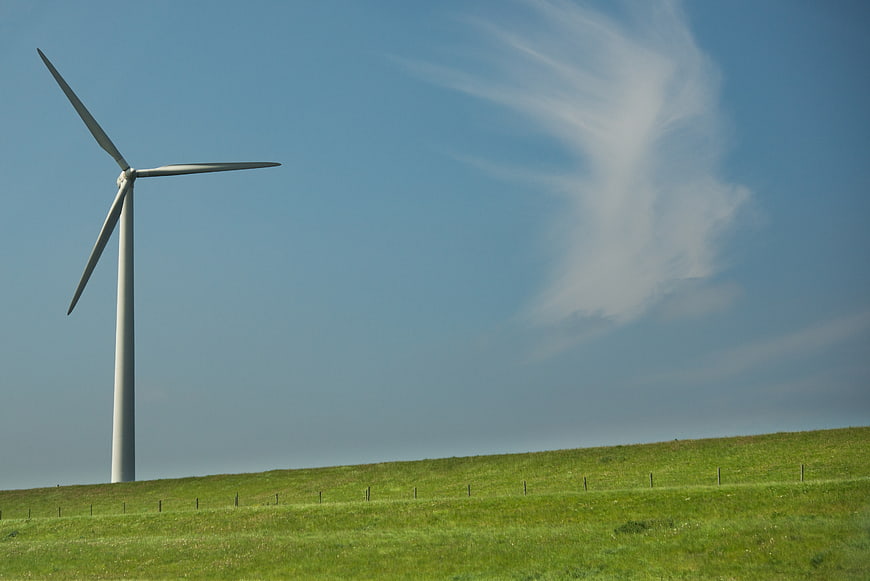 Wind Turbine on Green Hill with Blue Sky