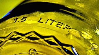 Close-up of 1.5 Liter Text on Yellow Glass Bottle