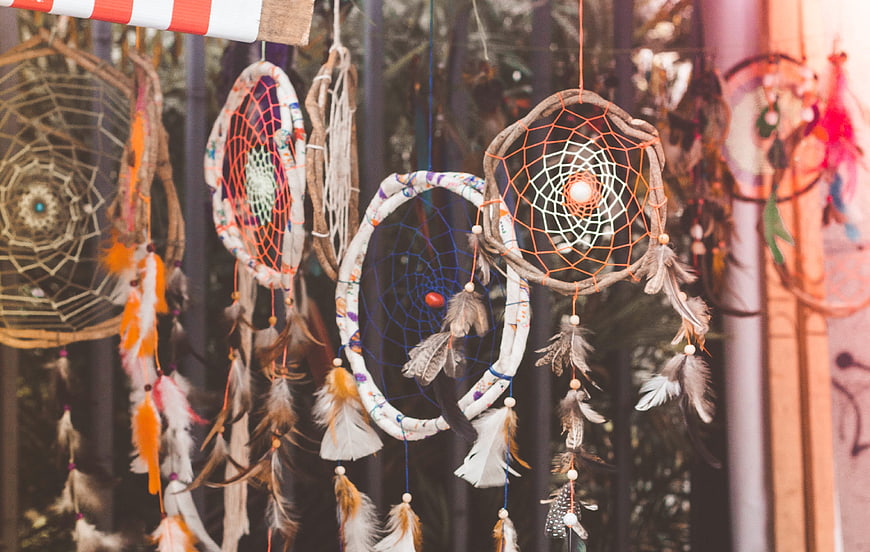Handmade Dreamcatchers with Feathers Hanging in Shop Window