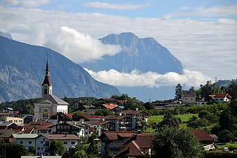 Alpine village with church and mountain backdrop