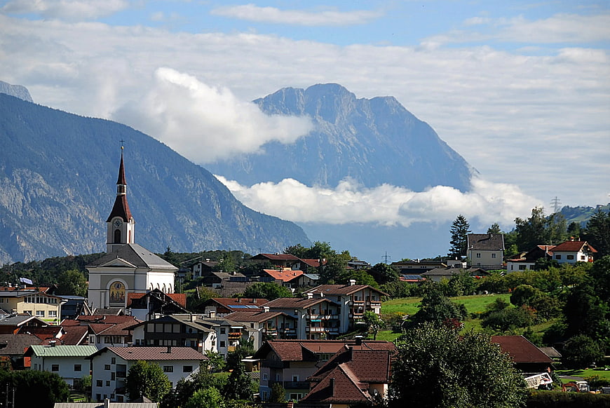 Alpine village with church and mountain backdrop