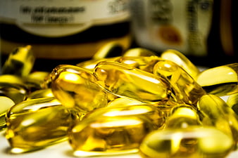 Close-up of golden omega-3 fish oil vitamin capsules