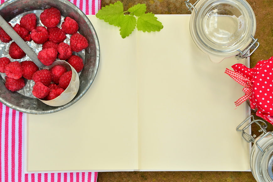 Fresh Raspberries and Recipe Book Flat Lay
