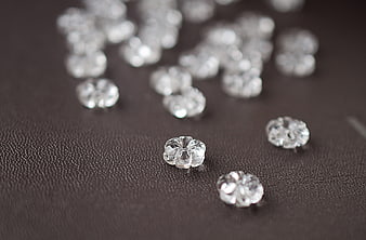 Clear glass flower beads on dark textured leather background