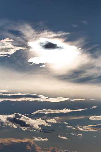 Dramatic Sunburst Through Clouds in Blue Sky