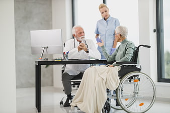 Senior Doctor Consulting Elderly Patient in Wheelchair