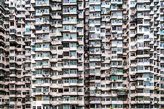 Dense Urban Housing Facade with Windows and Air Conditioners