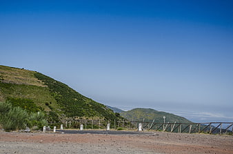 Mountain Road Viewpoint with Blue Sky and Green Hills