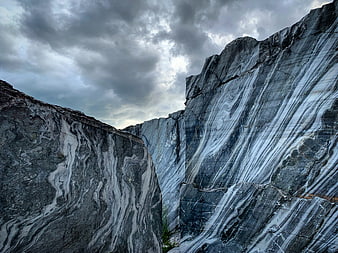 Dramatic marble quarry with swirling gray and white rock formations