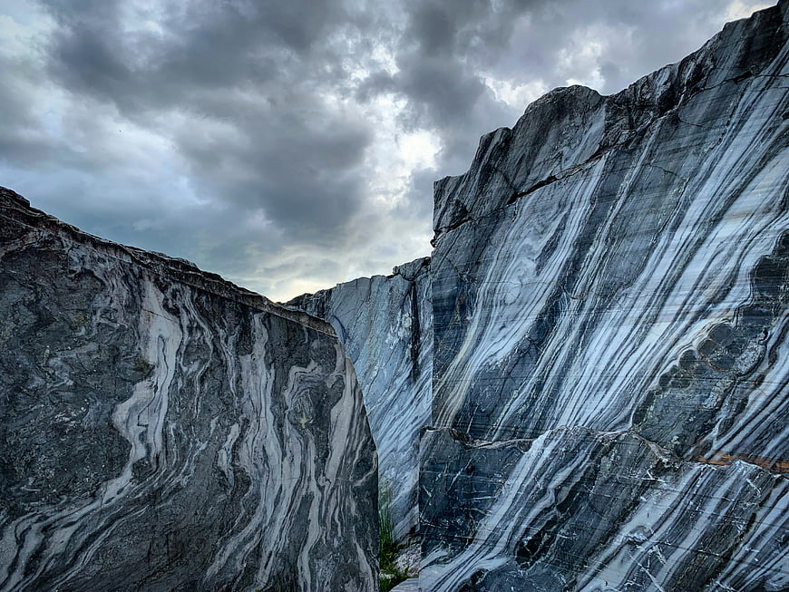 Dramatic marble quarry with swirling gray and white rock formations