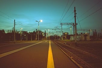 Empty Train Station Platform at Dusk with Yellow Safety Line