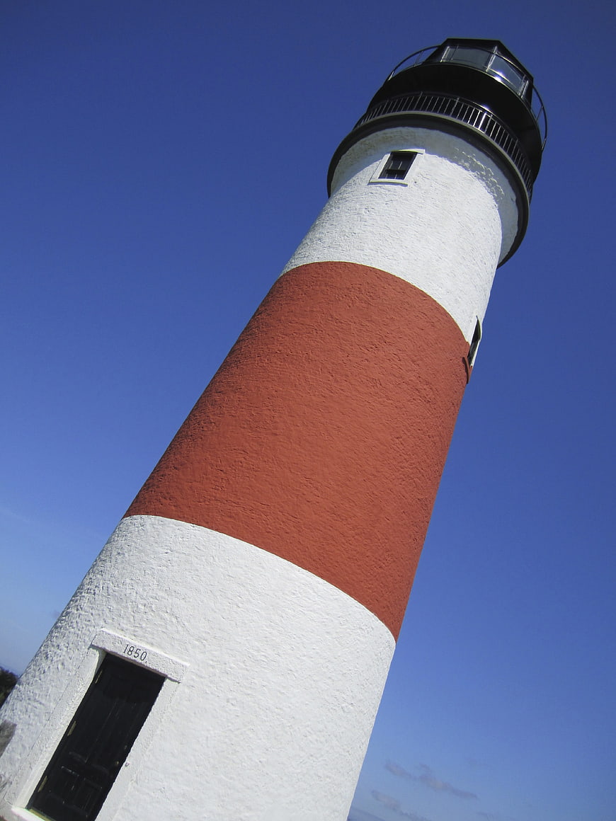 Low angle view of Sankaty Head Lighthouse against blue sky