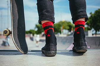 Skateboarder Feet with Red Socks at Skate Park