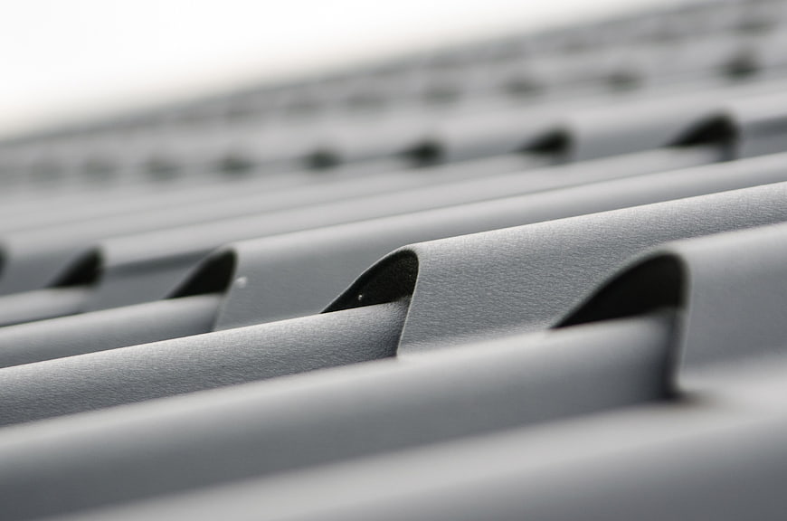 Close-up of gray corrugated metal roofing sheet texture