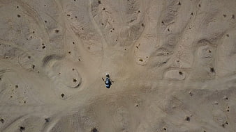 Aerial view of helicopter landing in desert sand