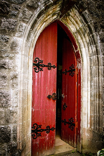 Old Red Wooden Church Door in Stone Archway