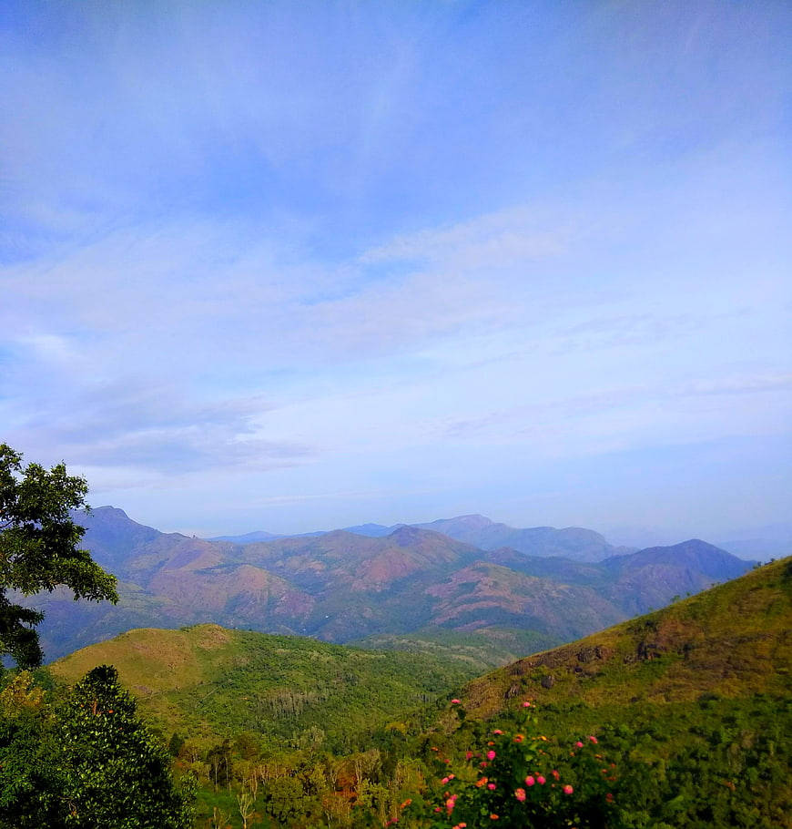 Scenic Mountain Landscape with Blue Sky and Green Hills