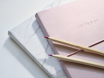 Pink Journal and Pencils on Marble Surface