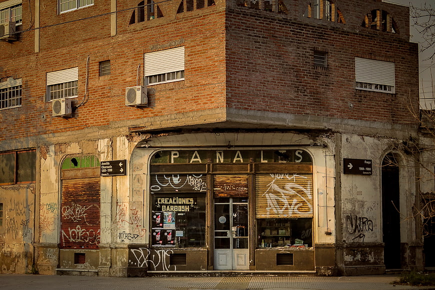 Old Brick Building with Graffiti and Abandoned Storefront