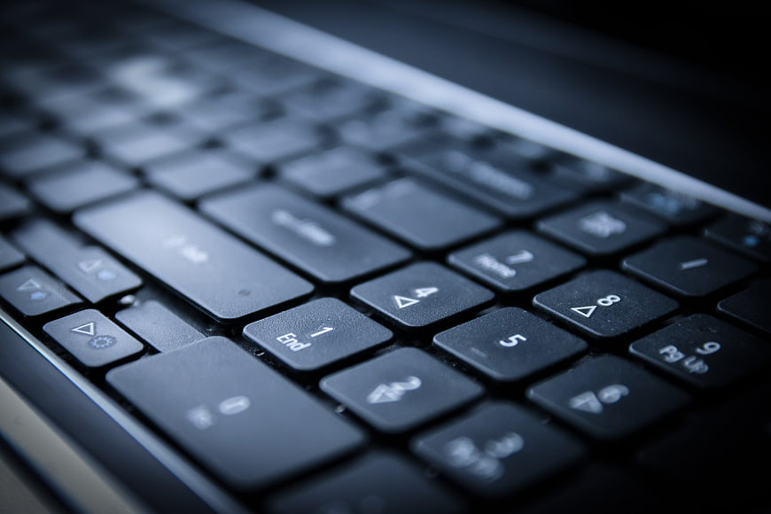 Close-up of black laptop keyboard with shallow depth of field