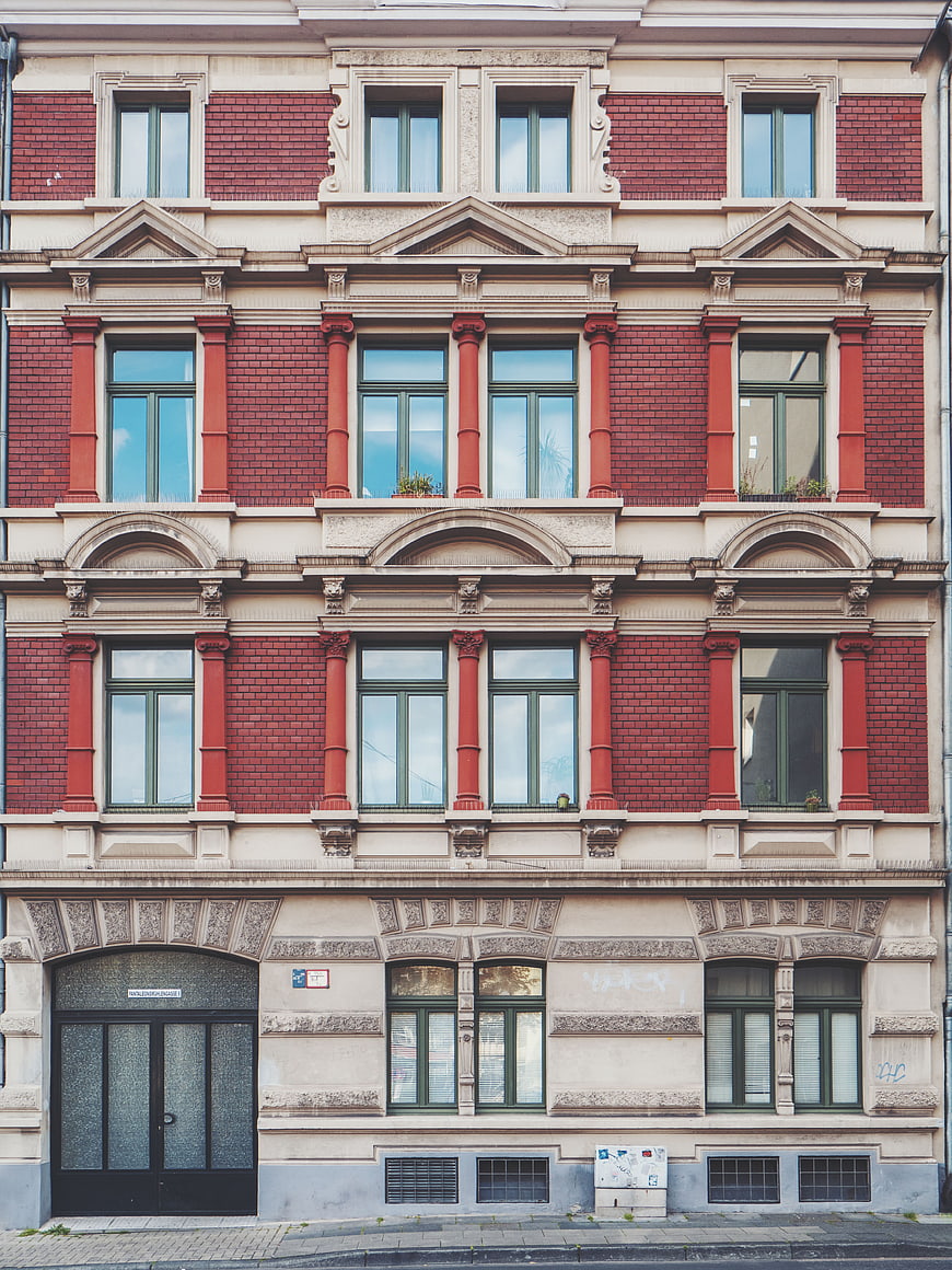 Symmetrical Red Brick Building Facade with Ornate Windows