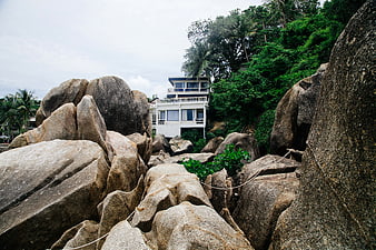 White House Nestled Among Large Granite Boulders and Tropical Trees