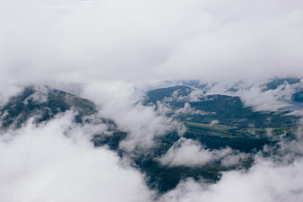 Misty mountain landscape with clouds and fog